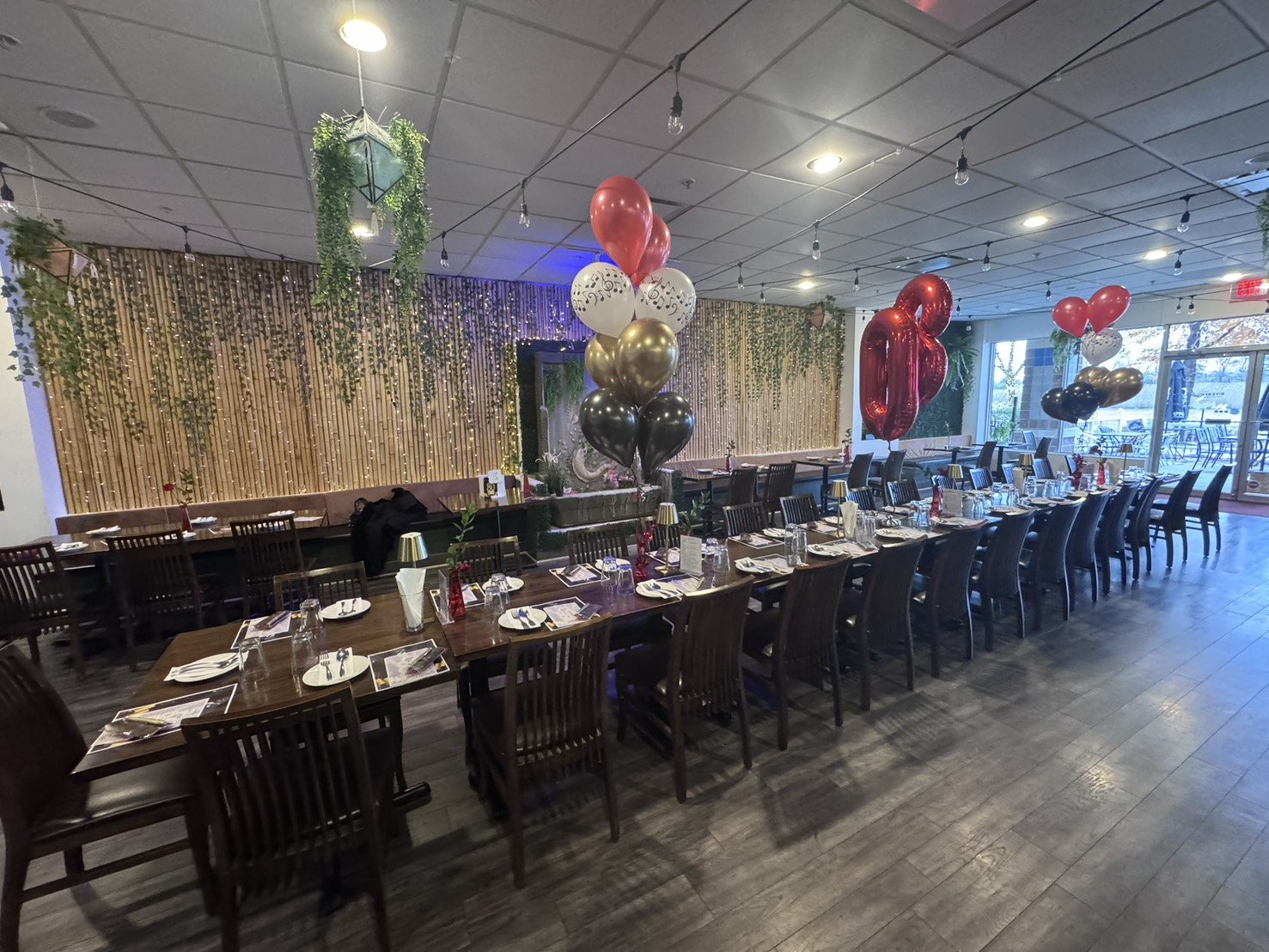 Long celebration table set with balloons